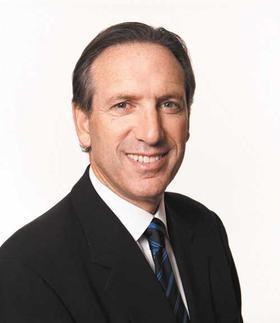 A year after meeting with Starbucks' founders, in 1982, Howard Schultz was hired as director of retail operations and marketing for the growing coffee company, which, at the time, only sold coffee beans, not coffee drinks. "My impression of Howard at that time was that he was a fabulous communicator," co-founder Zev Siegl later remembered. "One to one, he still is."  Early on, Schultz set about making his mark on the company while making Starbucks' mission his own. In 1983, while traveling in Milan, Italy, he was struck by the number of coffee bars he encountered. An idea then occurred to him: Starbucks should sell not just coffee beans but coffee drinks. "I saw something. Not only the romance of coffee, but ... a sense of community. And the connection that people had to coffee—the place and one another," Schultz recalled. "And after a week in Italy, I was so convinced with such unbridled enthusiasm that I couldn't wait to get back to Seattle to talk about the fact that I had seen the future."  Schultz's enthusiasm for opening coffee bars in Starbucks stores, however, wasn't shared by the company's creators. "We said, 'Oh no, that's not for us,'" Siegl remembered. "Throughout the '70s, we served coffee in our store. We even, at one point, had a nice, big espresso machine behind the counter. But we were in the bean business." Nevertheless, Schultz was persistent until, finally, the owners let him establish a coffee bar in a new store that was opening in Seattle. It was an instant success, bringing in hundreds of people per day and introducing a whole new language—the language of the coffeehouse—to Seattle in 1984.  But the success of the coffee bar demonstrated to the original founders that they didn't want to go in the direction Schultz wanted to take them. They didn't want to get big. Disappointed, Schultz left Starbucks in 1985 to open a coffee bar chain of his own, Il Giornale, which quickly garnered success.  Two years later, with the help of investors, Schultz purchased Starbucks, merging Il Giornale with the Seattle company. Subsequently, he became CEO and chairman of Starbucks (known thereafter as the Starbucks Coffee Company). Schultz had to convince investors that Americans would actually shell out high prices for a beverage that they were used to getting for 50 cents. At the time, most Americans didn't know a high-grade coffee bean from a teaspoon of Nescafé instant coffee. In fact, coffee consumption in the United States had been going down since 1962.   In 2000, Schultz publicly announced that he was resigning as Starbucks' CEO. Eight years later, however, he returned to head the company. In a 2009 interview with CBS, Schultz said of Starbucks' mission, "We're not in the business of filling bellies; we're in the business of filling souls."