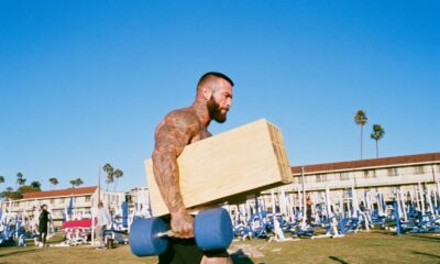 Man motivated while he carries weights and is pumped up and inspired