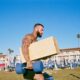 Man motivated while he carries weights and is pumped up and inspired