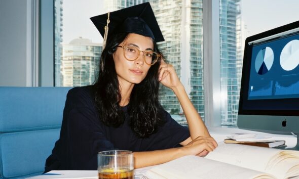 A Female MBA graduate working on a business plan on her computer