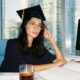 A Female MBA graduate working on a business plan on her computer
