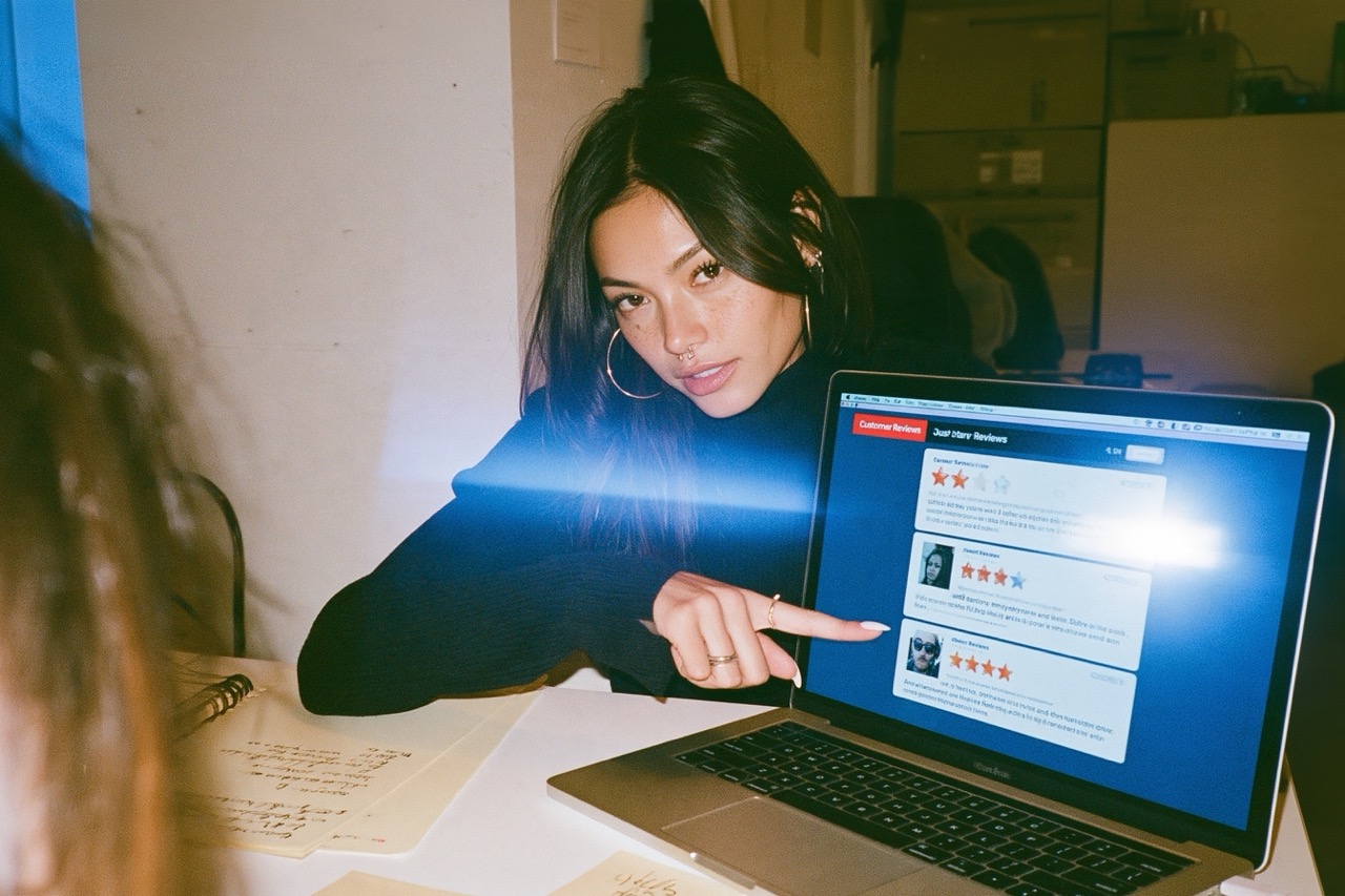 A female Entrepreneur looking at reviews on their online business store