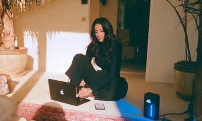 A female founder with a digital setup with her hard drive, laptop and smartphone