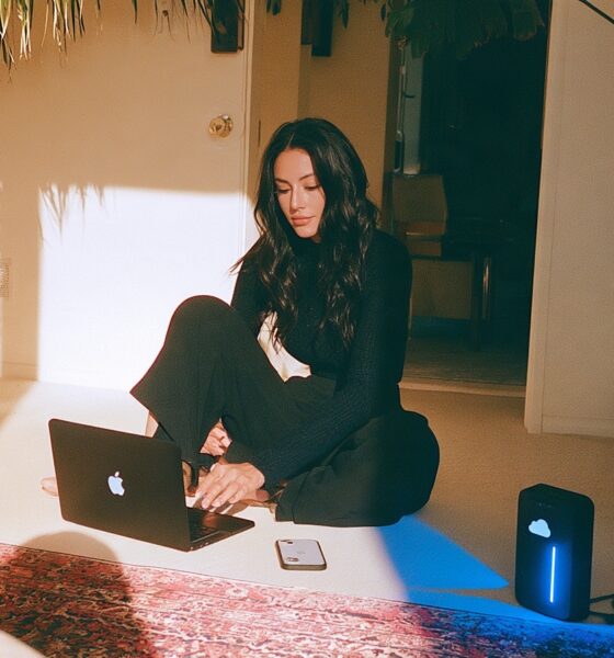 A female founder with a digital setup with her hard drive, laptop and smartphone