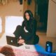 A female founder with a digital setup with her hard drive, laptop and smartphone