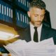 A male lawyer looking through records to help his client win a case