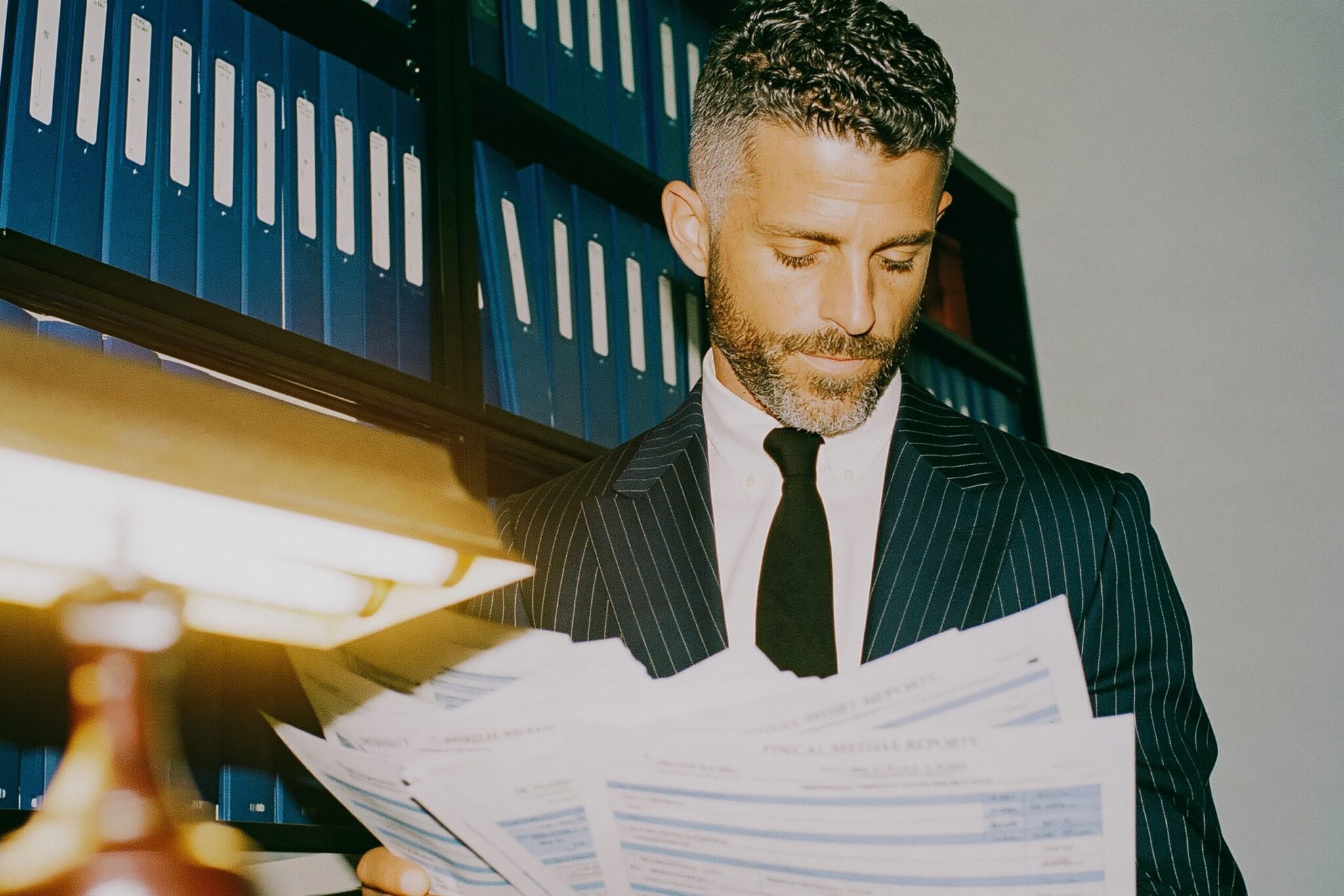 A male lawyer looking through records to help his client win a case