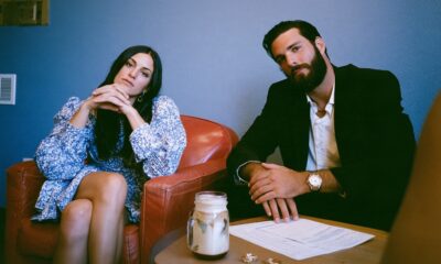 A man and woman getting a divorce with their rings on the table and paperwork