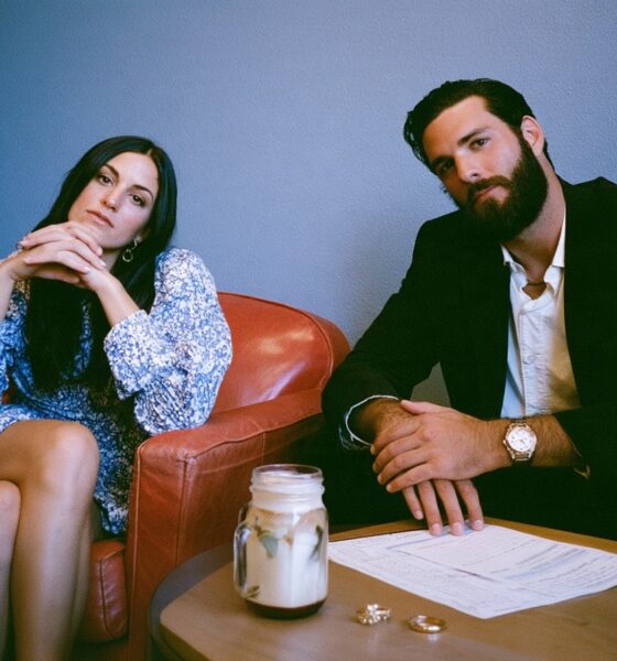 A man and woman getting a divorce with their rings on the table and paperwork