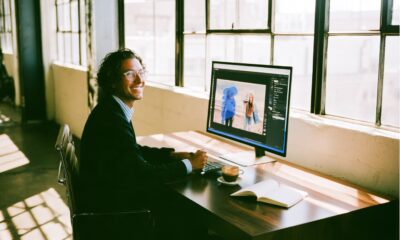 A man sitting on his computer creating images with an AI image generator