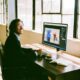 A man sitting on his computer creating images with an AI image generator