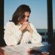 A woman sitting at her desk looking at debt relief options
