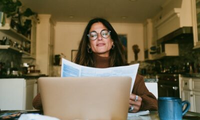 An entrepreneur Woman filing her medical claim while she is on her laptop in the kitchen