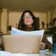 An entrepreneur Woman filing her medical claim while she is on her laptop in the kitchen