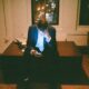 An entrepreneur founder staring at his phone in his office late at night feeling overwhelmed with tasks to do