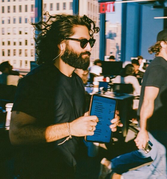 An entrepreneur man holding a digital tablet excited about his AI agents he just built