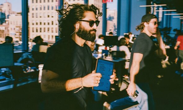 An entrepreneur man holding a digital tablet excited about his AI agents he just built
