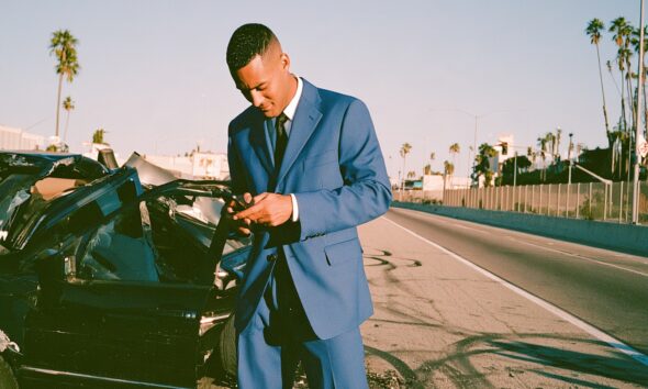 Entrepreneur man in a car crash on his phone
