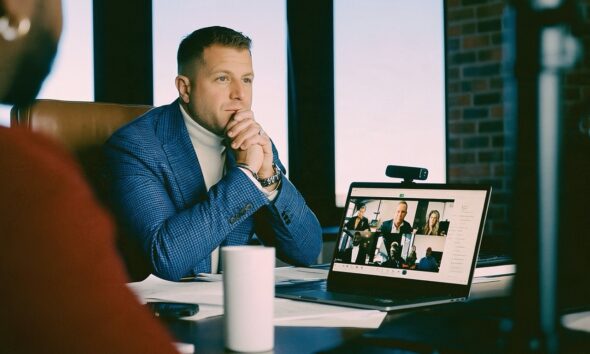 Male Founder sitting at desk on a zoom call using an AI note taker