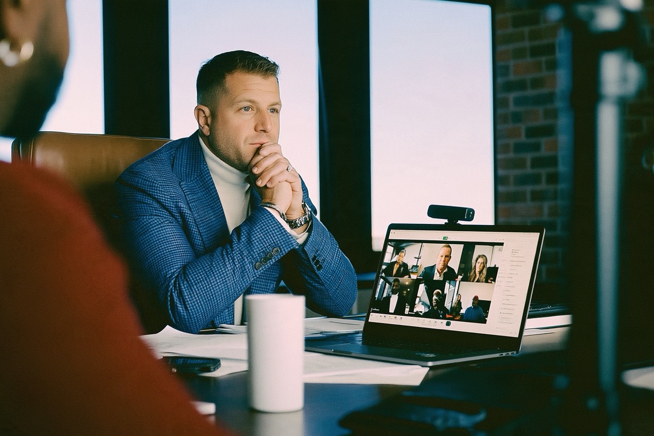 Male Founder sitting at desk on a zoom call using an AI note taker