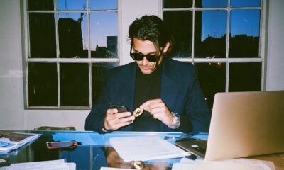 Man looking at his crypto trades in his home office