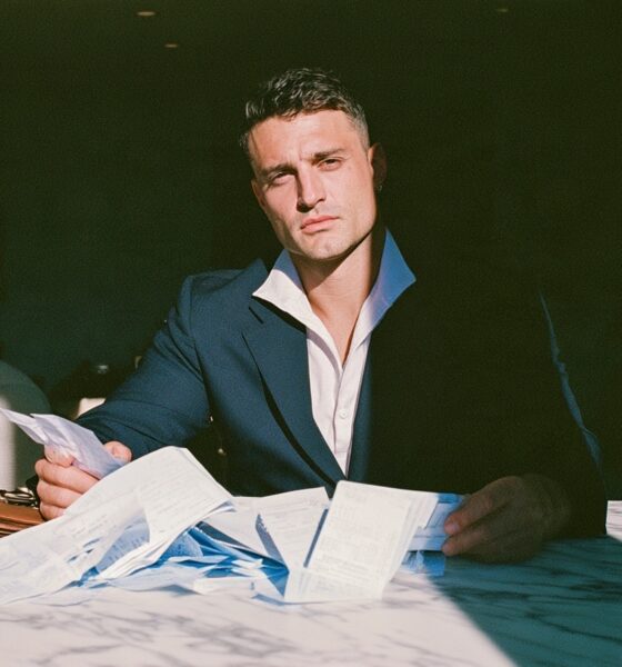 Man looking at his finances and he is trying to work out how to save more money for his startup business