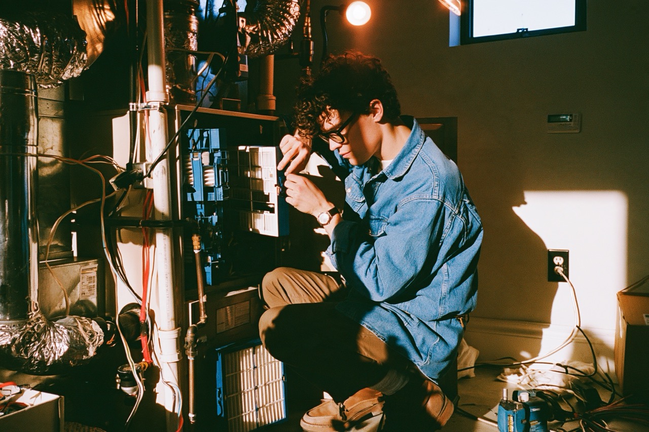 Man working on a furnace in his basement