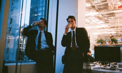 Two lazy workers in the office who are starting work late