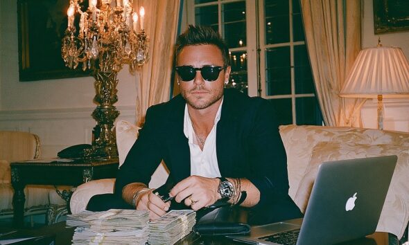 Wealthy man managing his money with his credit card and cash