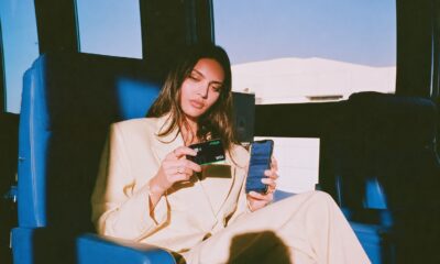 Woman holding black Maya bank card