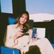Woman holding black Maya bank card