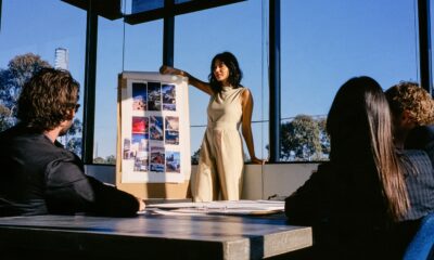 Woman standing at the front of a room pitching her marketing strategy to her creative team