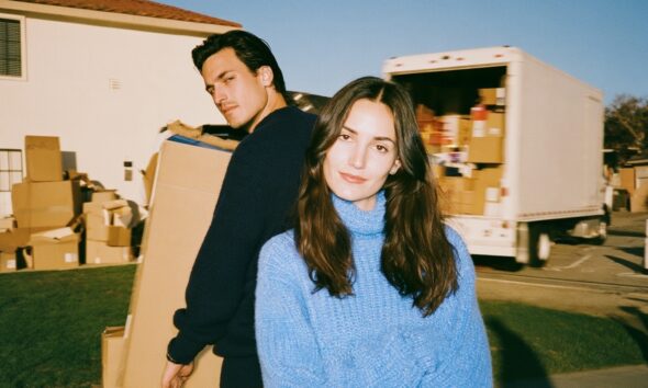 a confident male and female good looking couple high net worth individuals who are into real estate and are moving from one house to another