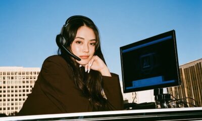 woman with headset on for calls with digital AI on the screen