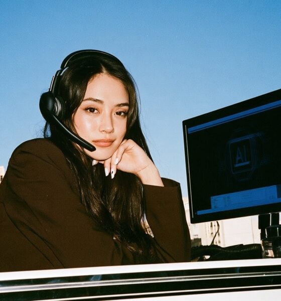 woman with headset on for calls with digital AI on the screen