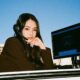 woman with headset on for calls with digital AI on the screen